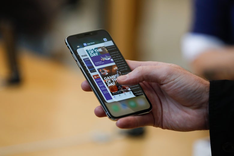 An Apple employee demonstrates the app switcher on the new iPhone X at the Apple Store Union Square on November 3, 2017, in San Francisco, California.
Apple's flagship iPhone X hits stores around the world as the company predicts bumper sales despite the handset's eye-watering price tag, and celebrates a surge in profits. / AFP PHOTO / Elijah Nouvelage        (Photo credit should read ELIJAH NOUVELAGE/AFP/Getty Images)