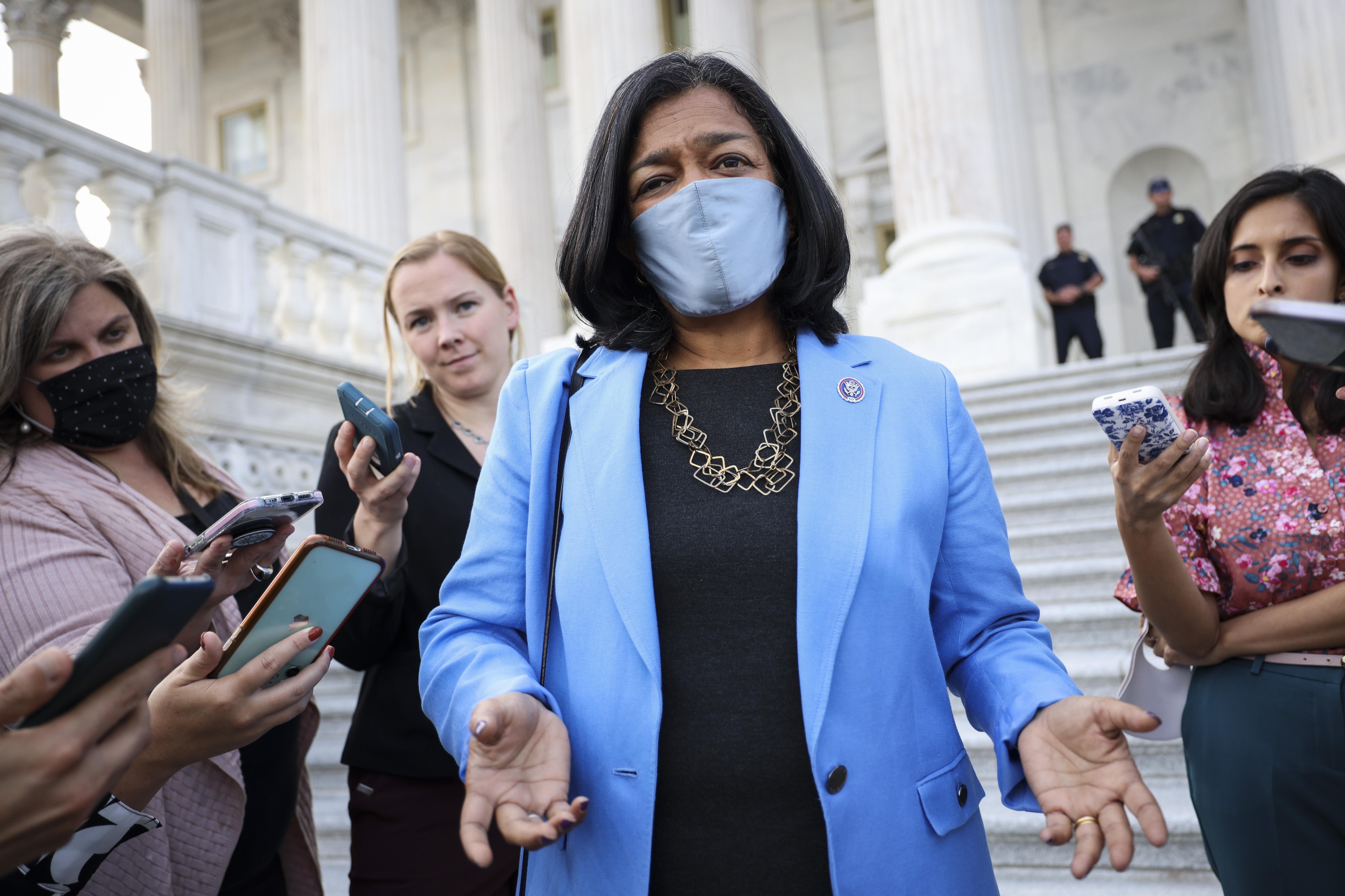 Jayapal in a mask speaks to reporters on the Capitol steps