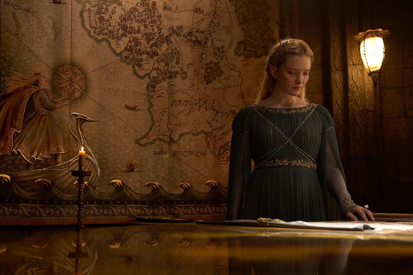 Galadriel standing in front of a map of Middle-earth.