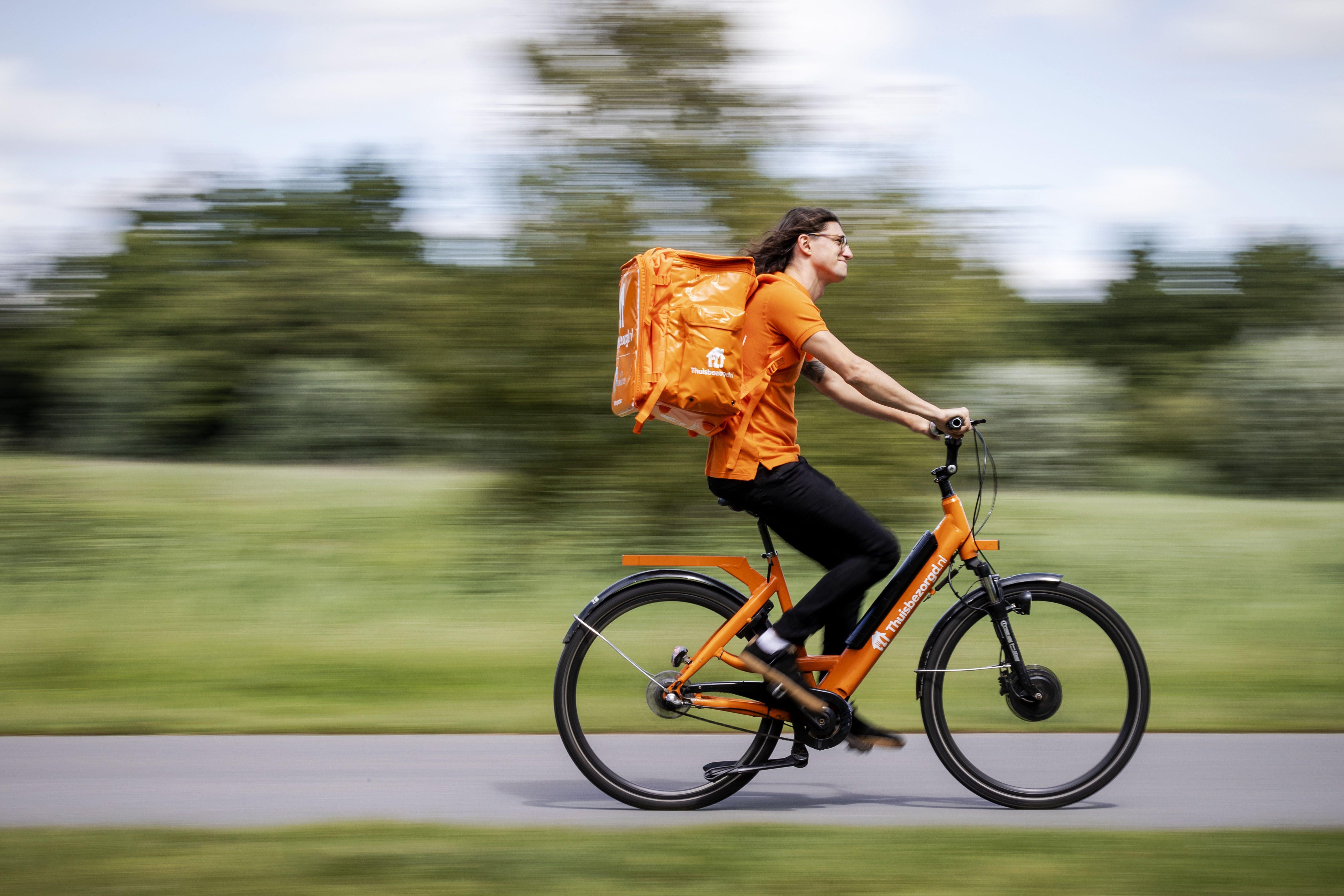 A man rides an e-bike as he delivers food.