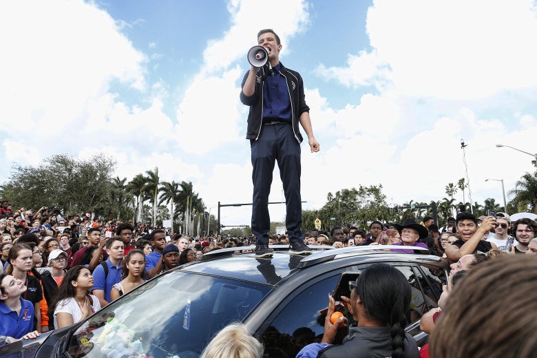 Majory Stoneman High School student Cameron Kasky addresses students as they rally after participating in a countywide school walkout in Parkland, Florida, on Wednesday.