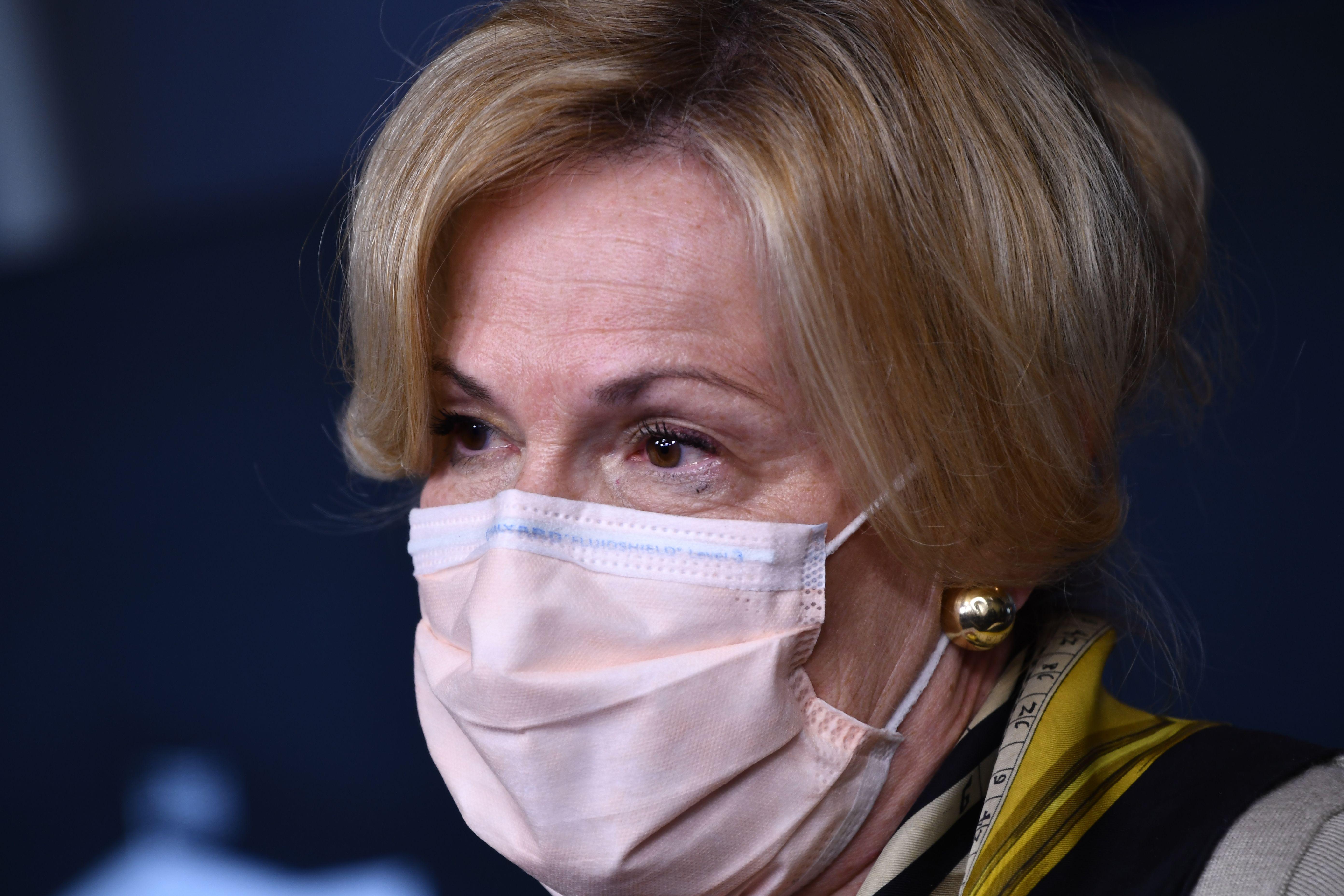 A close-up of Deborah Birx, wearing a surgical mask and one of her trademark scarves.