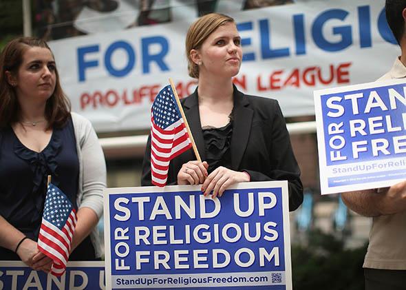 Religious freedom supporters hold a rally to praise the Supreme Court's decision in the Hobby Lobby.
