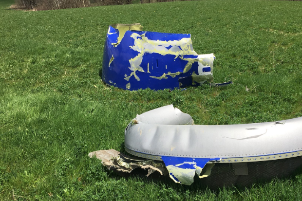 Two engine fragments on a grass field.