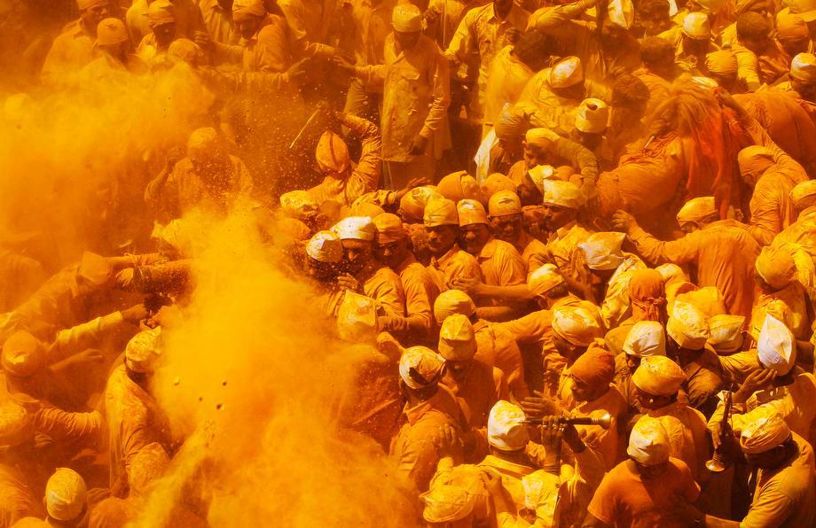 Devotees throw turmeric powder as an offering to the shepherd god Khandoba on "Somavati Amavasya" at the Jejuri temple in Pune district, Maharashtra state, India, on March 11, 2013. "Somavati Amavasya" is when a New Moon falls on a Monday.