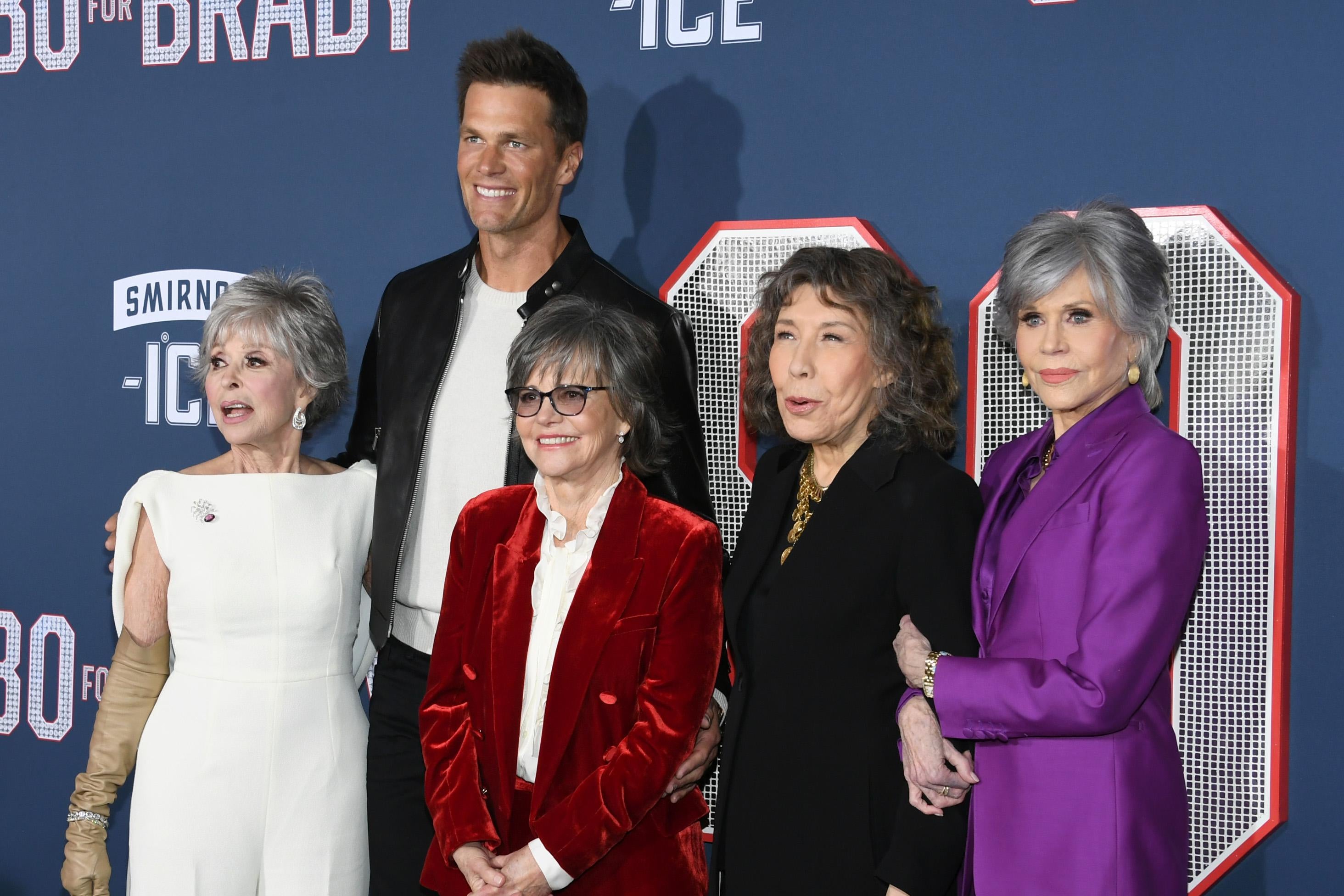 Rita Moreno, Tom Brady, Sally Field, Lily Tomlin, and Jane Fonda posing for photos at the 80 for Brady premiere.