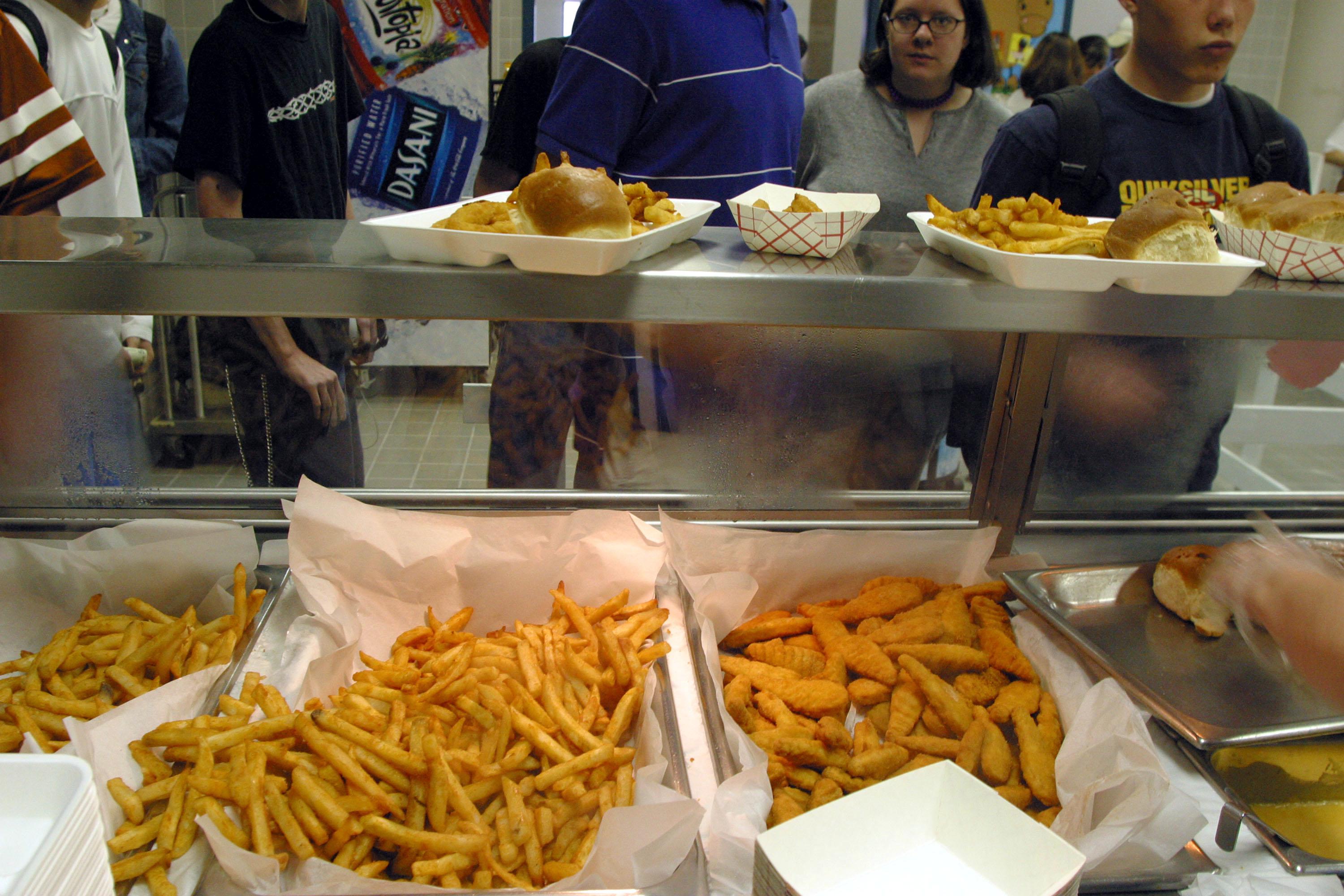 Students line up to receive food during lunch in the cafeteria at Bowie High School March 11, 2004 in Austin, Texas.