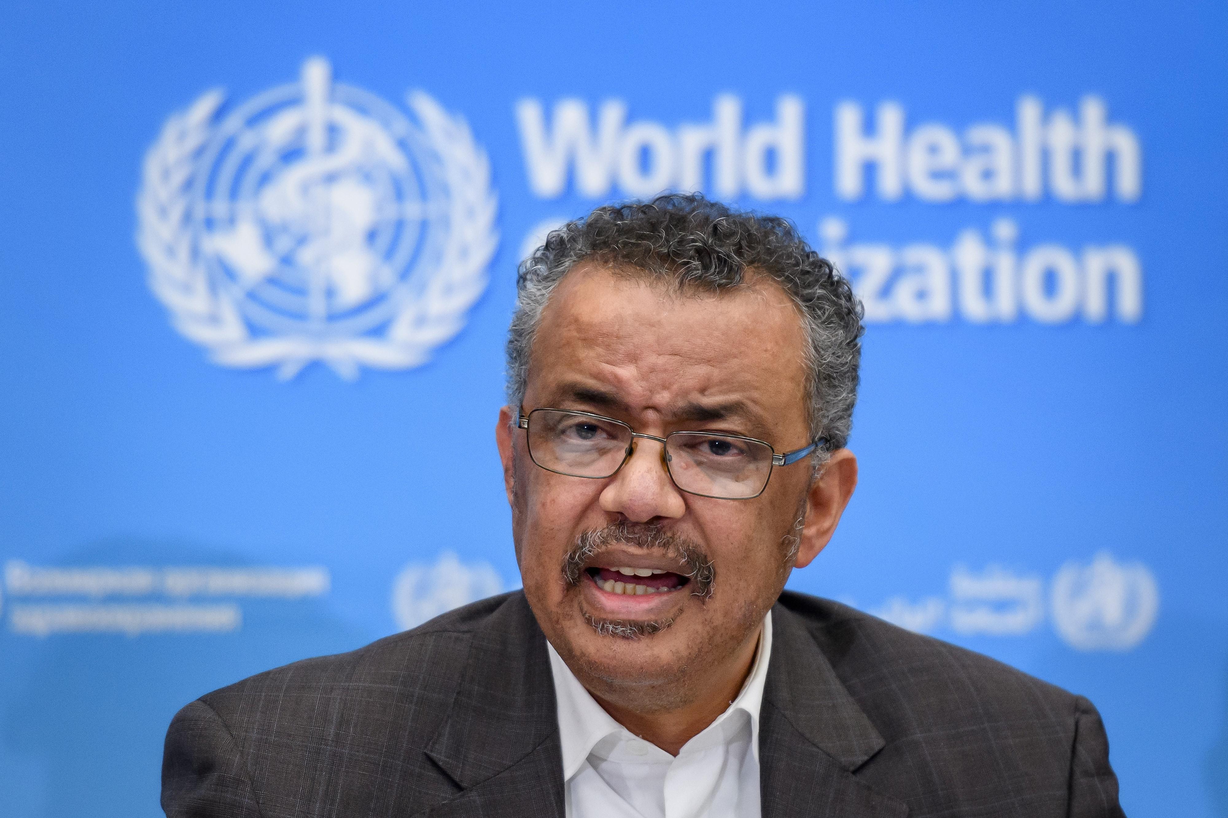Tedros Adhanom Ghebreyesus in front of a World Health Organization–branded backdrop.