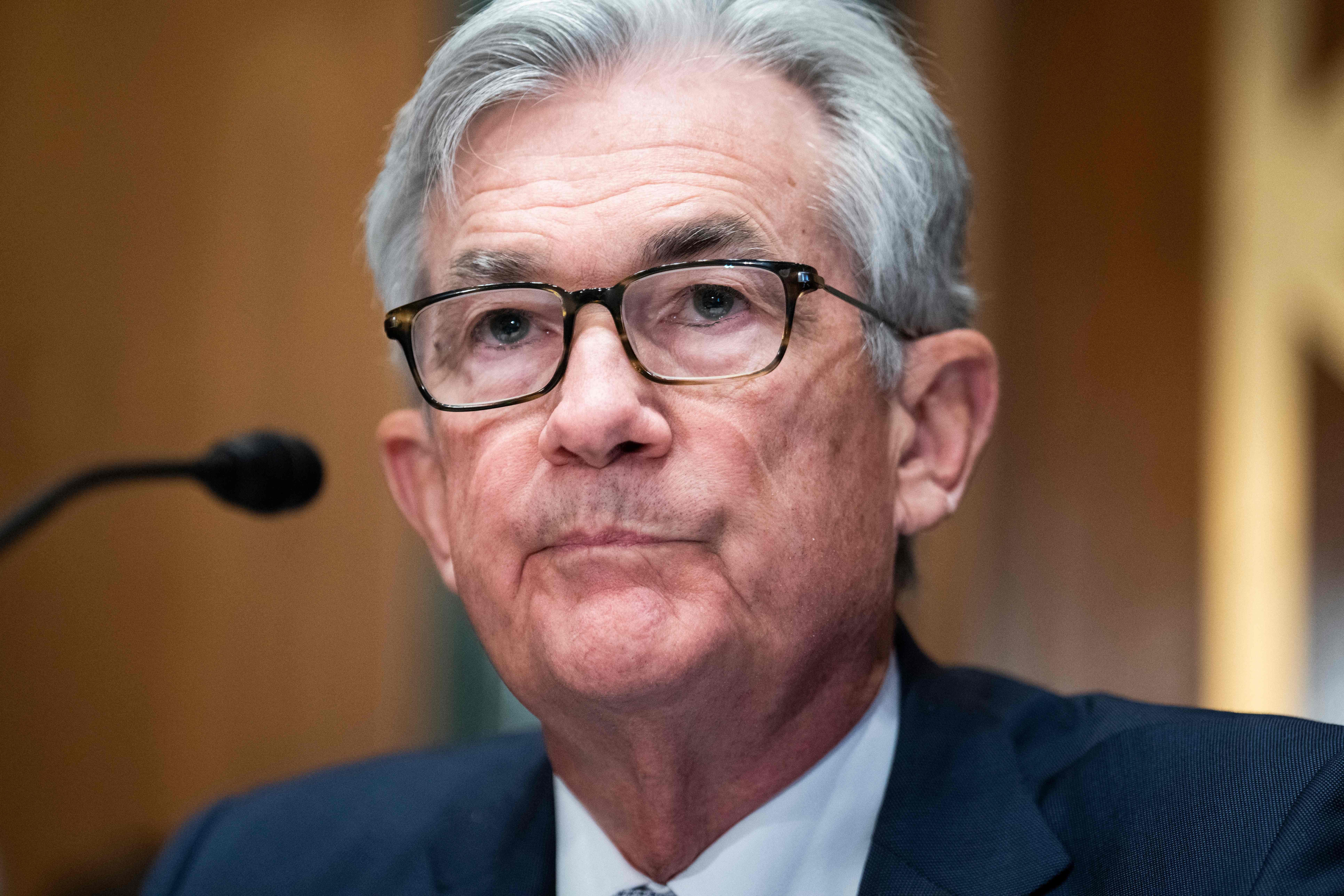 Close-up of Powell sitting in front of a mic
