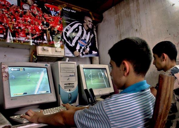 Palestinian young men at an Internet cafe in the West Bank city of Nablus, June 2006.