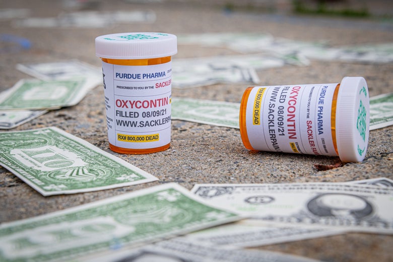 Fake OxyContin pill bottles and fake dollar bills on the ground. 