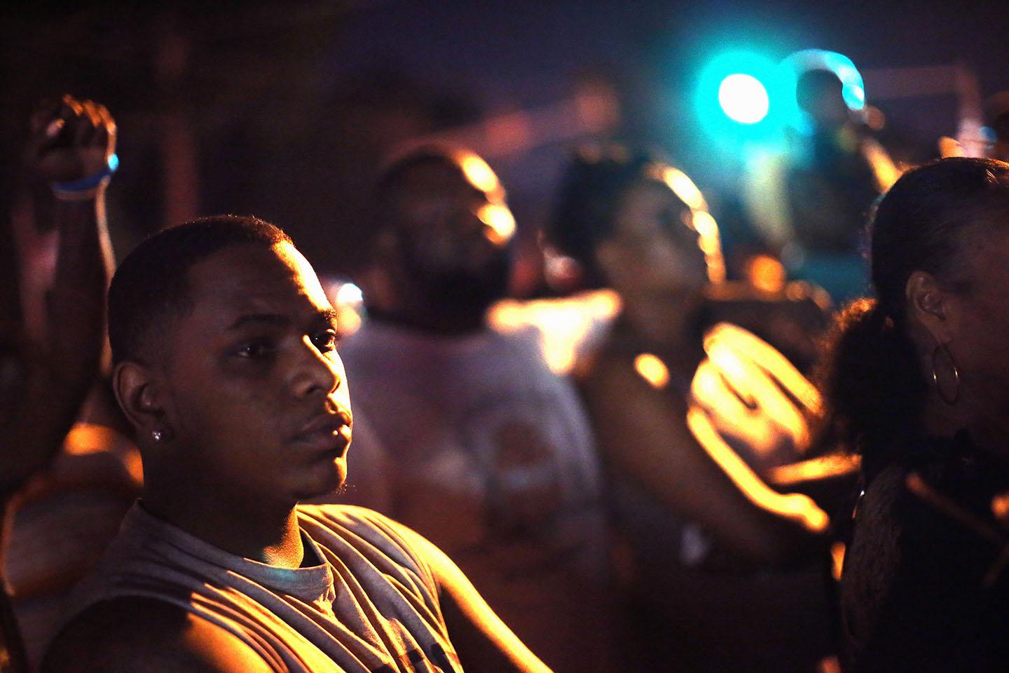 Demonstrators protest the killing of teenager Michael Brown.