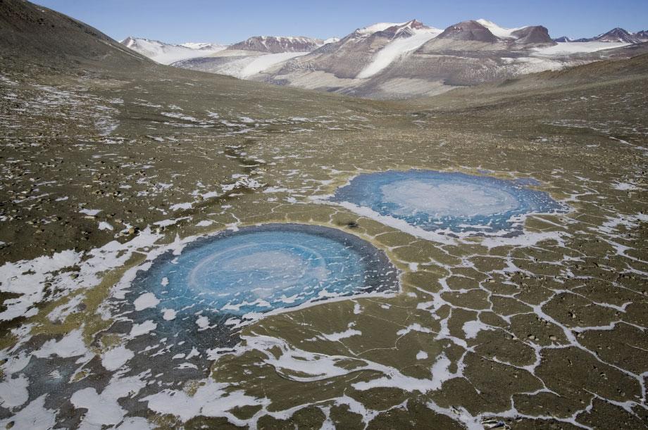 McMurdo Dry Val le y s, Antarc t ic a Near the top of Bull Pass, a helicopter’s shadow falls on the permafrost between a pair offrozen lakes. This is the largest ice-free area in Antarctica and is Earth’s closest equivalent to the polar regions on Mars.