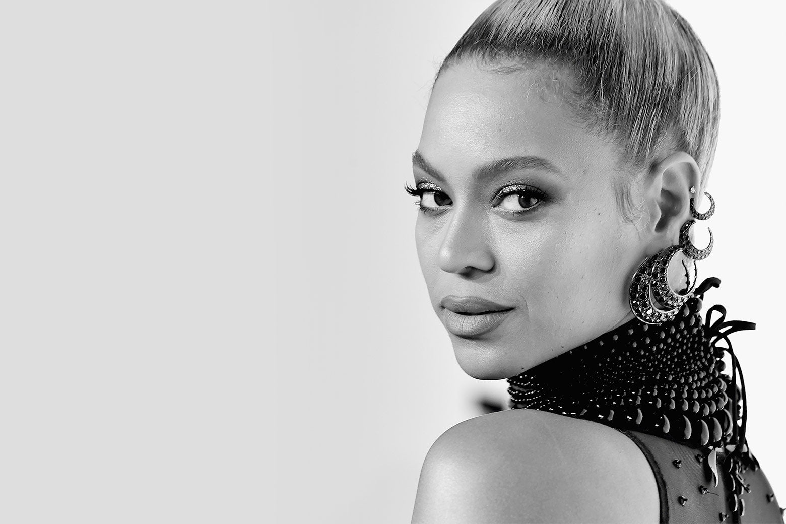 Beyone looks over her shoulder at the camera in a black-and-white photo.