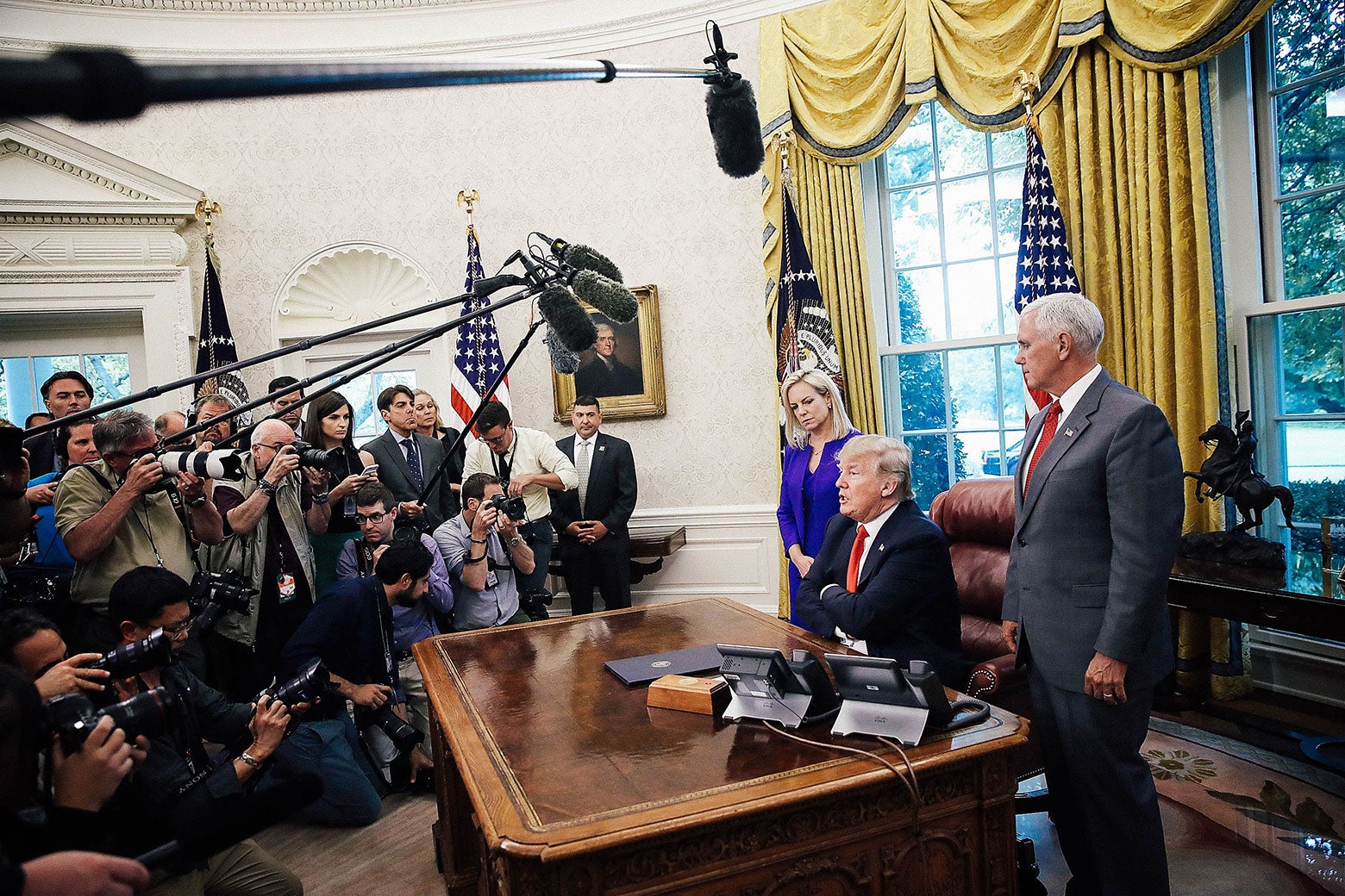 President Donald Trump, accompanied by Department of Homeland Security Secretary Kirstjen Nielsen and Vice President Mike Pence.