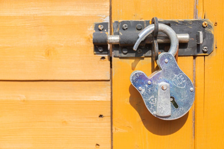 a yellow gate and an opening lock