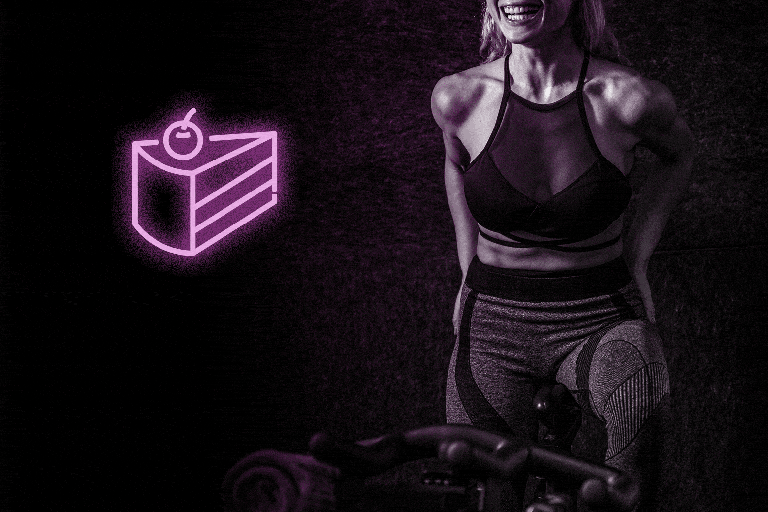 A woman rides an exercise bike next to a floating neon slice of cake.