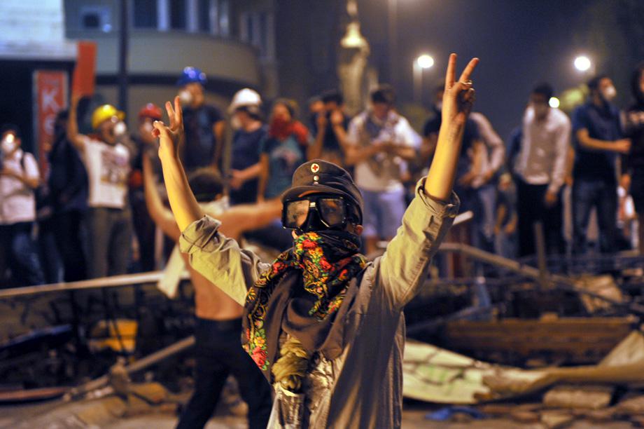 A protestor flashes a V-sign during the clashes near Taksim in Istanbul on June 3, 2013.