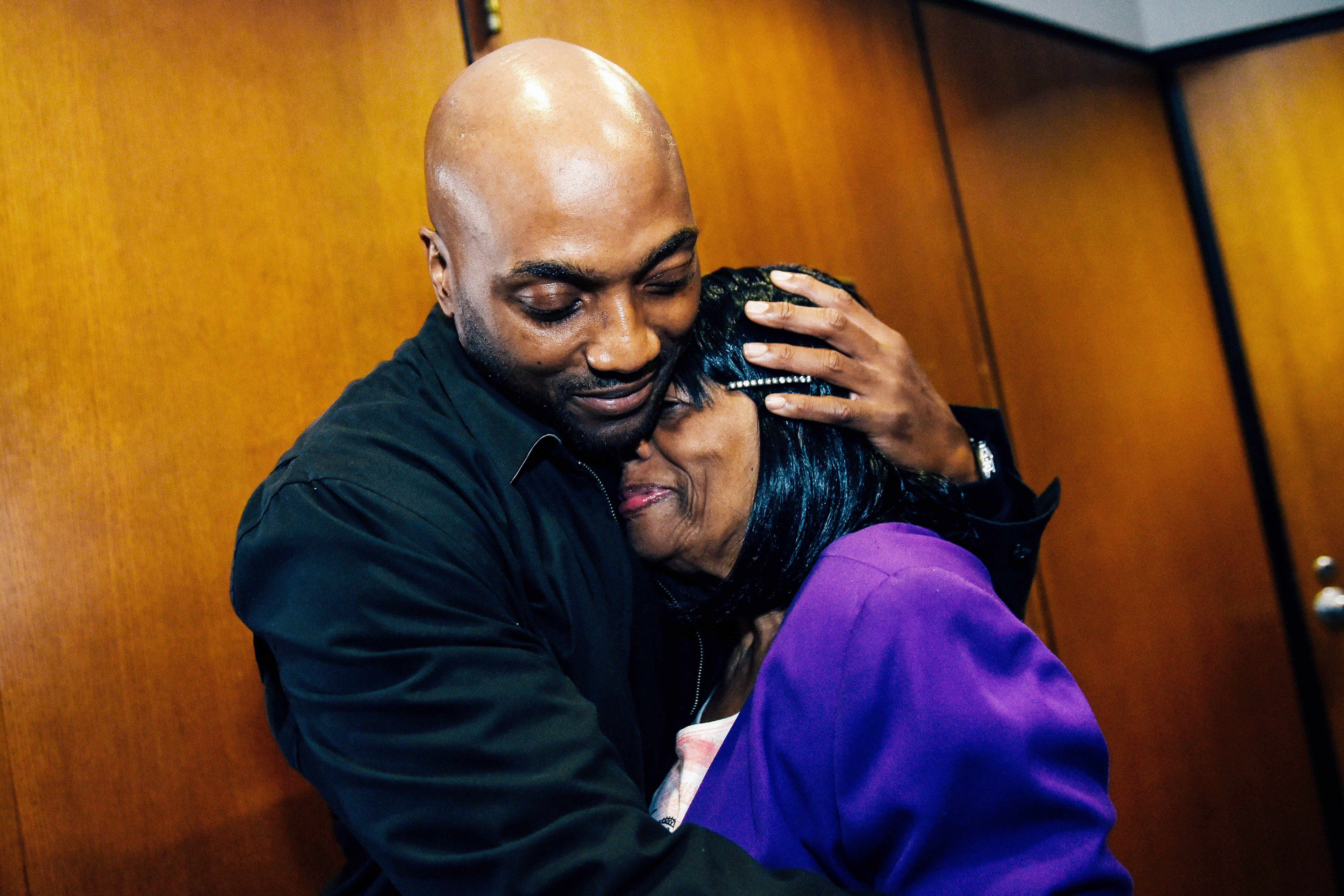 Lamarr Monson, hugs his mother, Delores Monson, after all charges were dismissed against him in the 1996 slaying of 12-year-old Detroiter Christina Brown.
