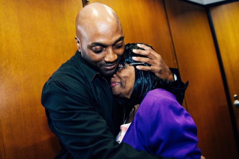 Lamarr Monson, hugs his mother, Delores Monson, after all charges were dismissed against him in the 1996 slaying of 12-year-old Detroiter Christina Brown.