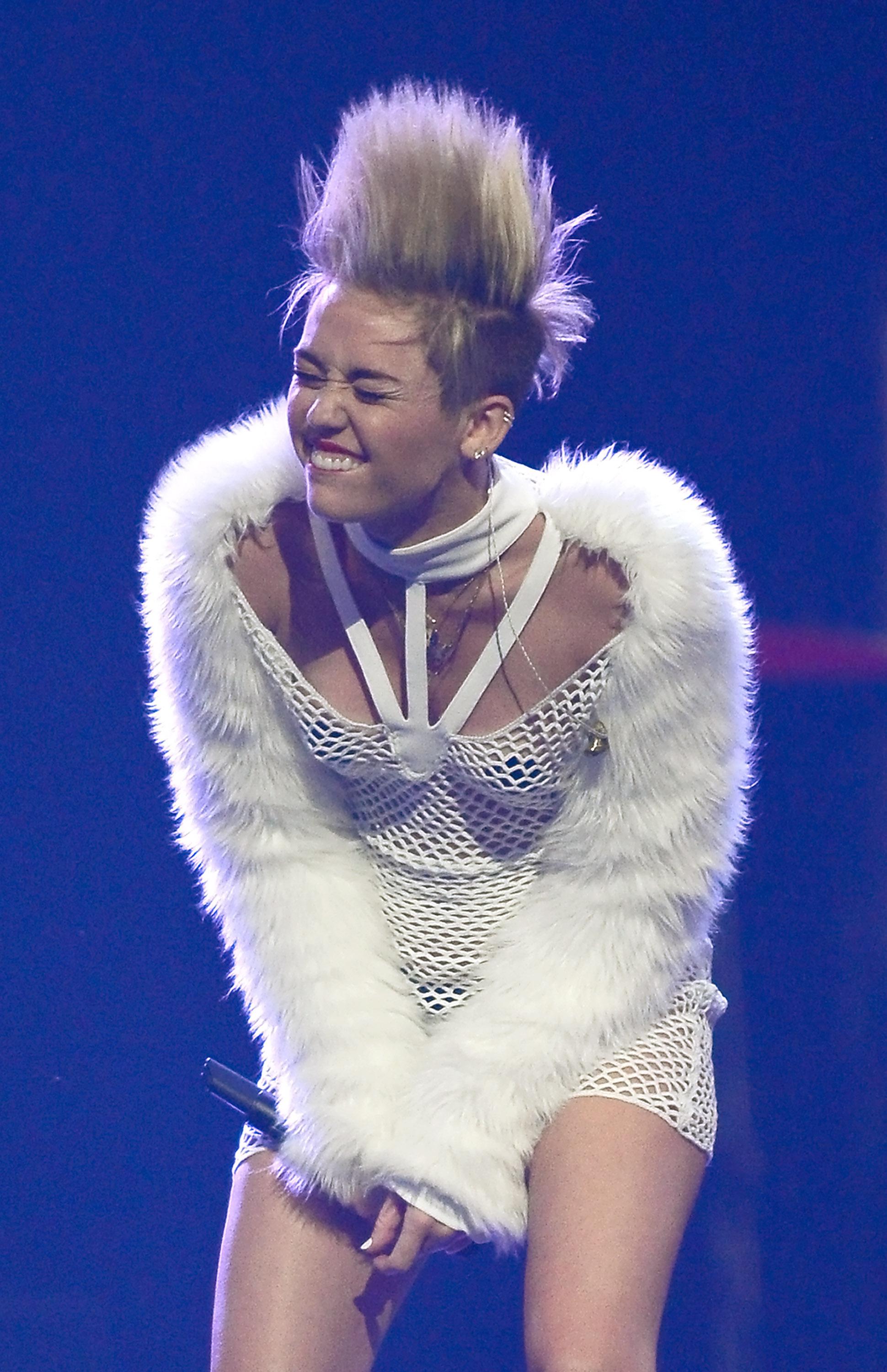 Miley Cyrus performing with spiked hair