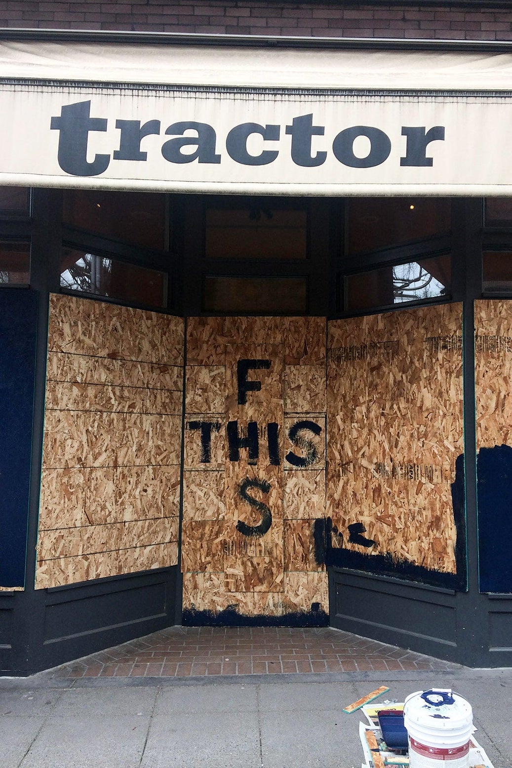 Boarded-up windows say "F This S."