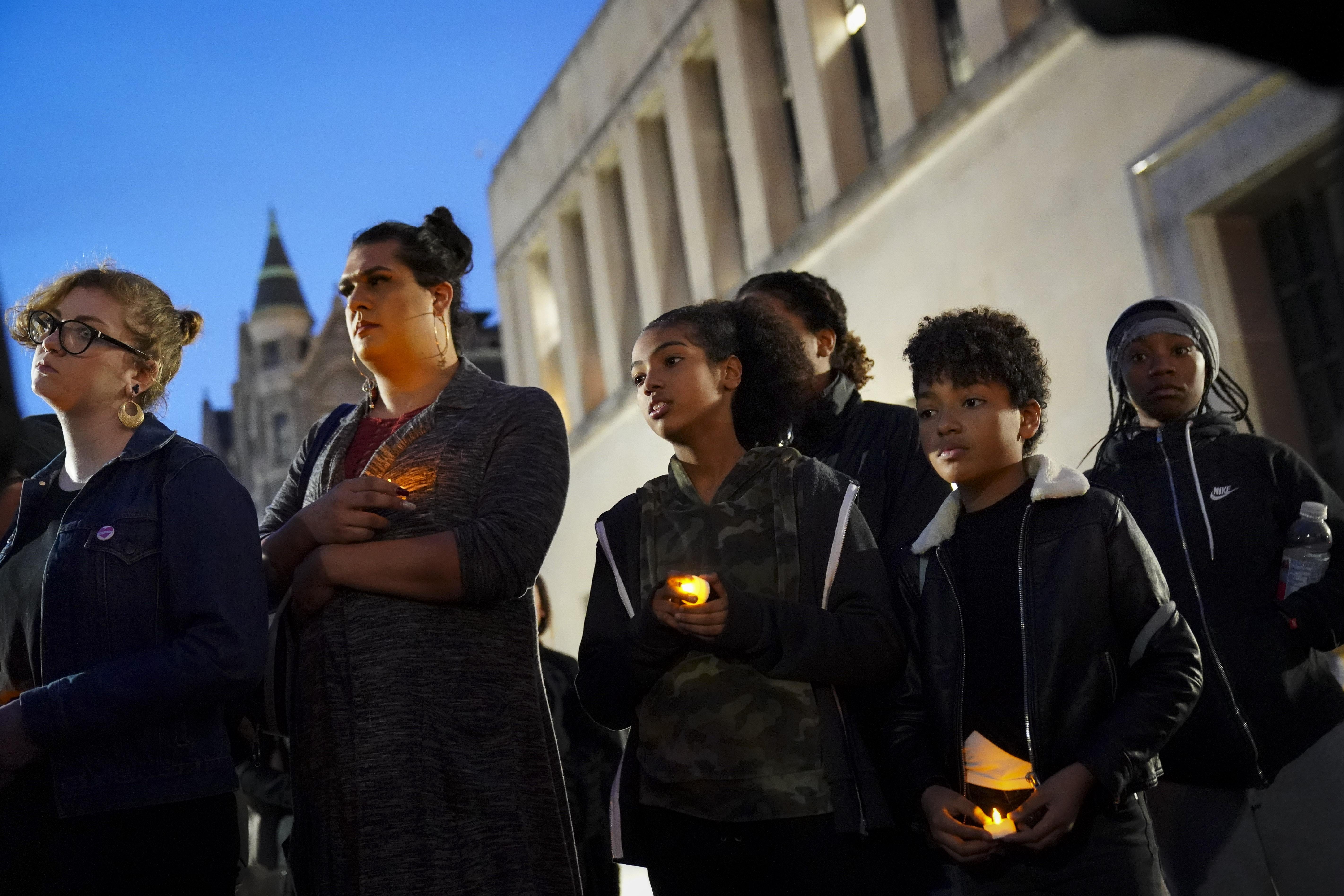 Protesters hold candles outside the Virginia State Capitol.