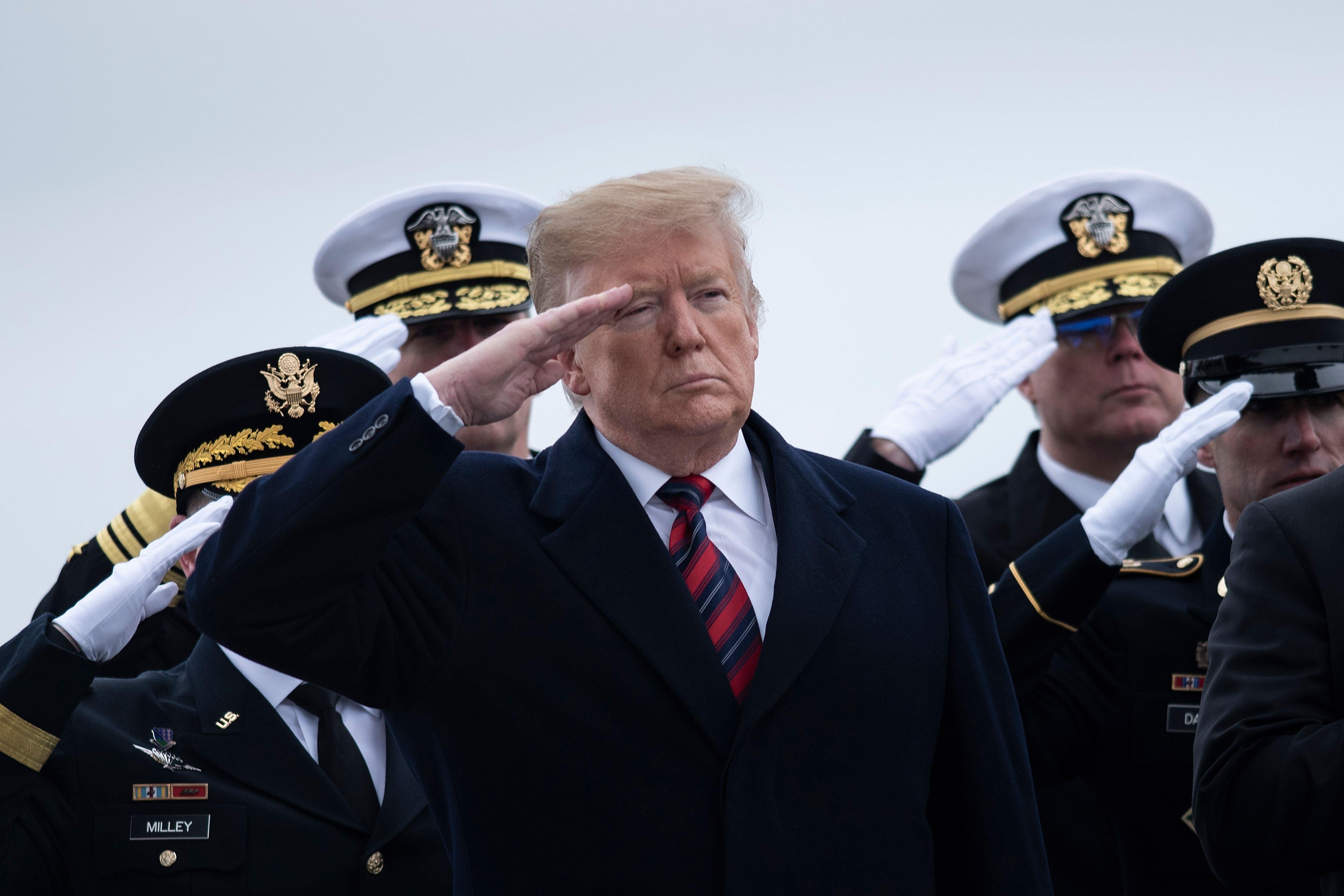 President Trump salutes while standing in front of officers at Dover Air Force Base Jan. 19, 2019 in Dover, Delaware.