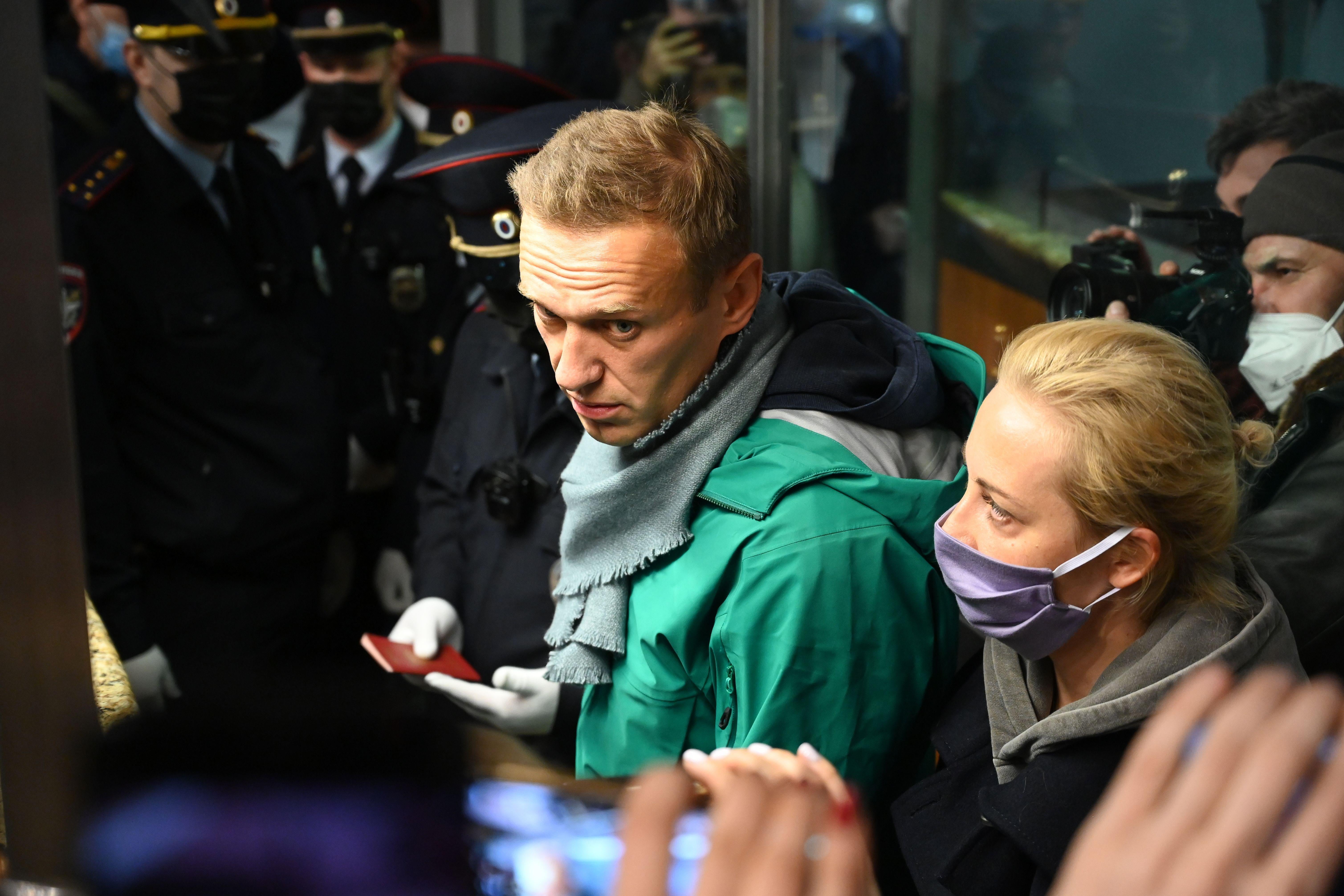 Russian opposition leader Alexei Navalny and his wife Yulia are seen at the passport control point at Moscow's Sheremetyevo airport on January 17, 2021.