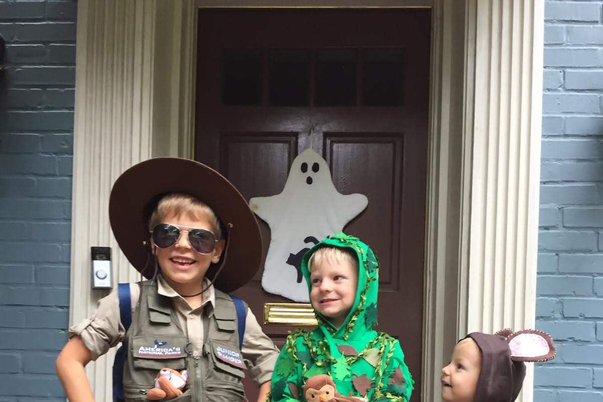 Elizabeth's sons dressed up for Halloween as a ranger, a tree, and a bear. 