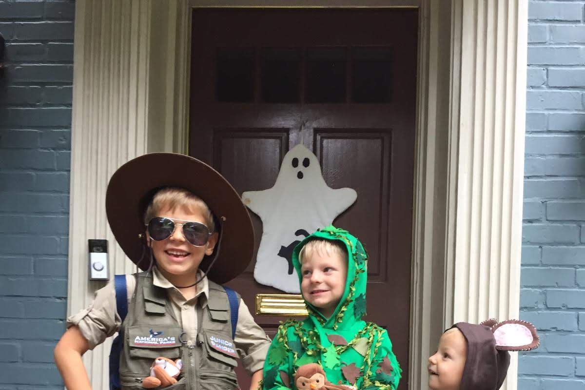 Elizabeth's sons dressed up for Halloween as a ranger, a tree, and a bear.
