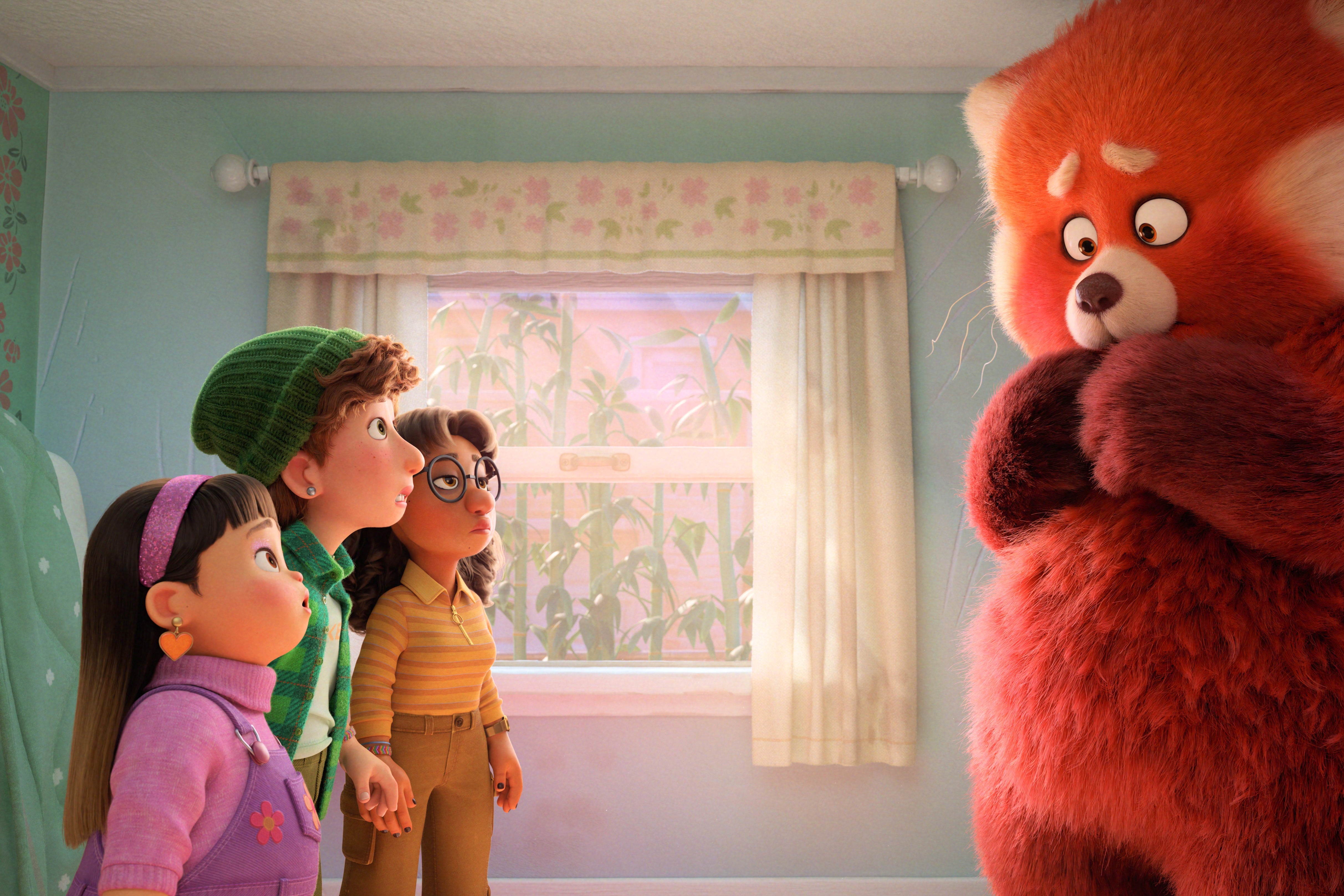 On one side of a pastel-colored bedroom, a diverse trio of computer-animated teenage girls looks up agog. On the other side, a giant red panda, its arms folded in front of it, wishing not to be perceived.