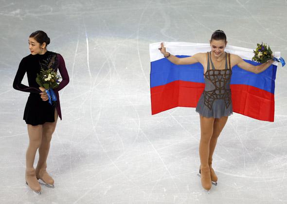 Gold medalist Adelina Sotnikova, right, and Youna Kim pose during the flower ceremony after Thursday's free skate at the Sochi Games.