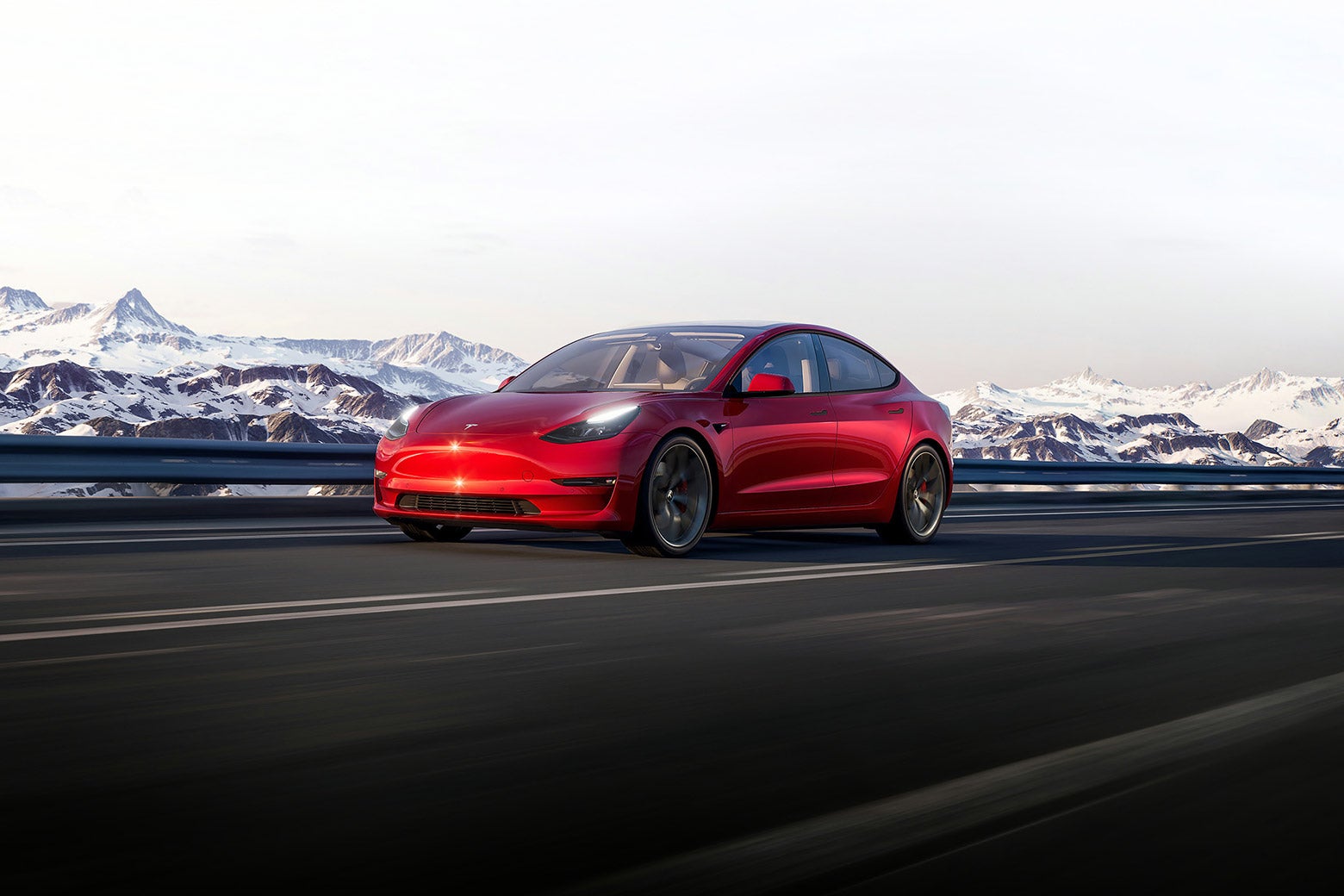 A Tesla sedan with a mountain landscape in the background. 