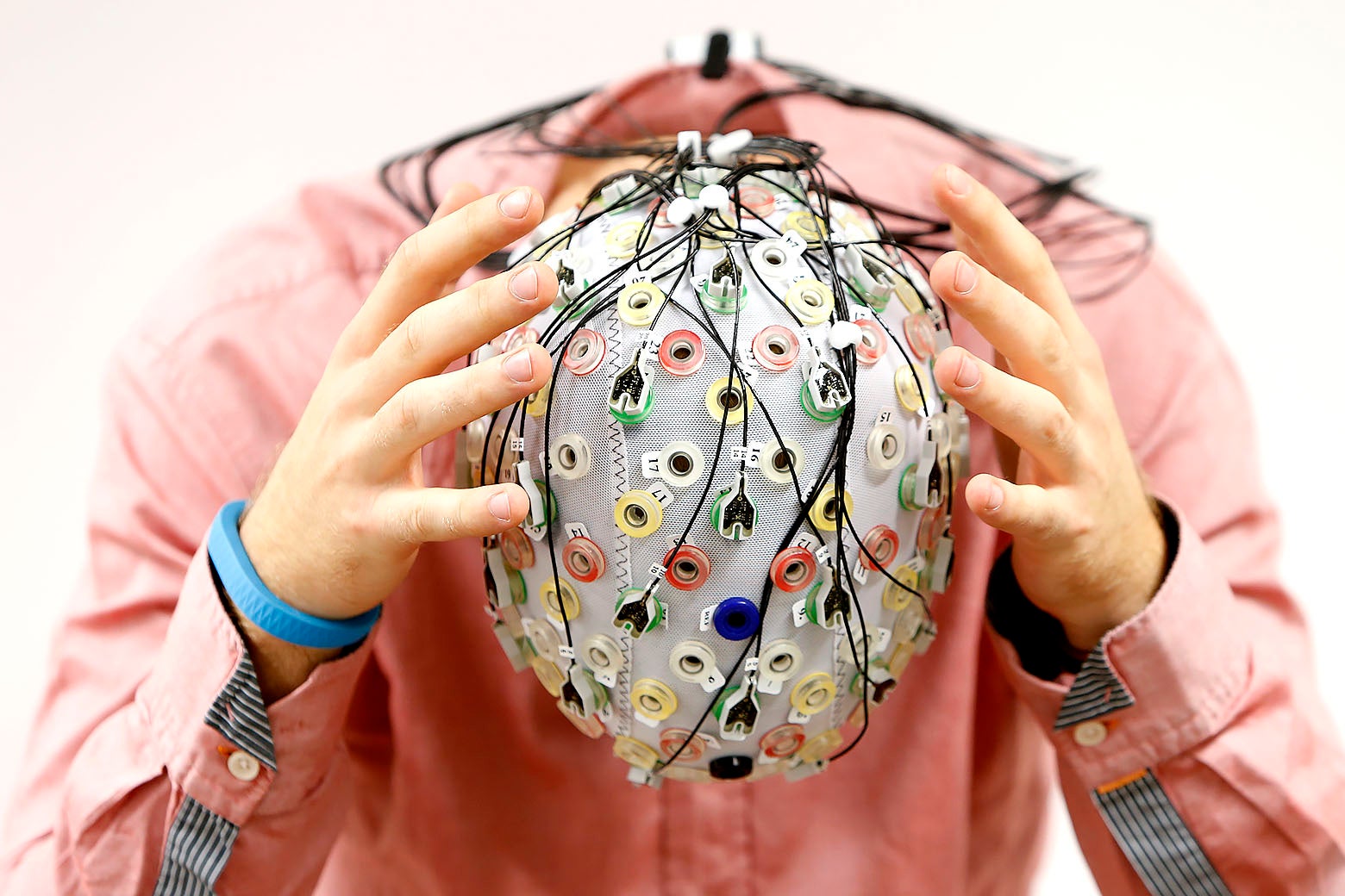 A person wearing an electroencephalography (EEG) cap.