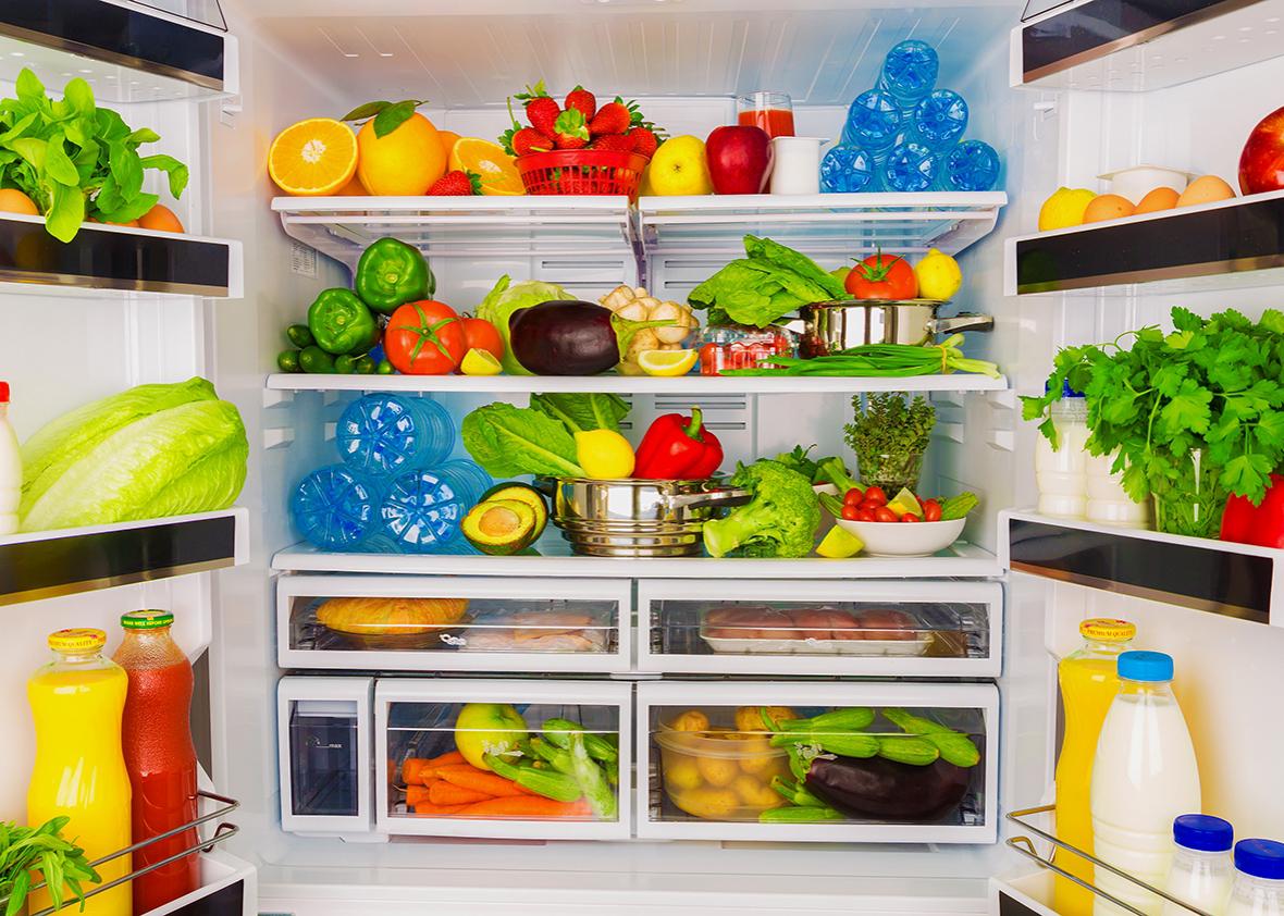 Open fridge full of fresh fruits and vegetable.