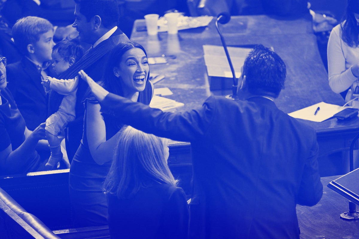 A woman smiles big in the midst of a chaotic scene in Congress.