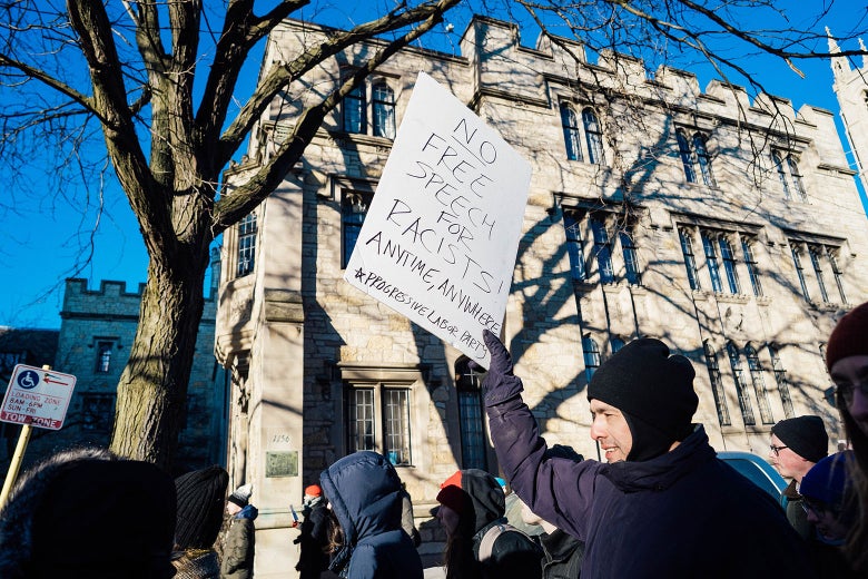 Demonstrator at the University of Chicago holding a sign that says, "No free speech for racists."