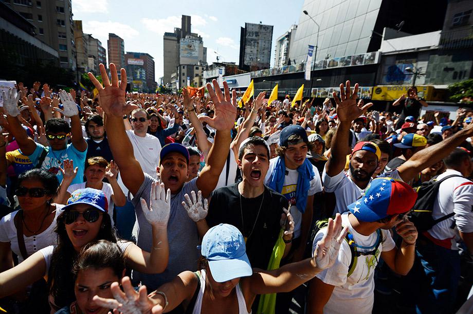 Anti-government students shout slogans during a protest in front of the Venezuelan Judiciary building in Caracas.