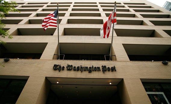 Flags wave in front of the Washington Post building on May 1, 2009, in Washington, D.C. The newspaper has announced its first-quarter earnings with a net loss of $19.5 million.