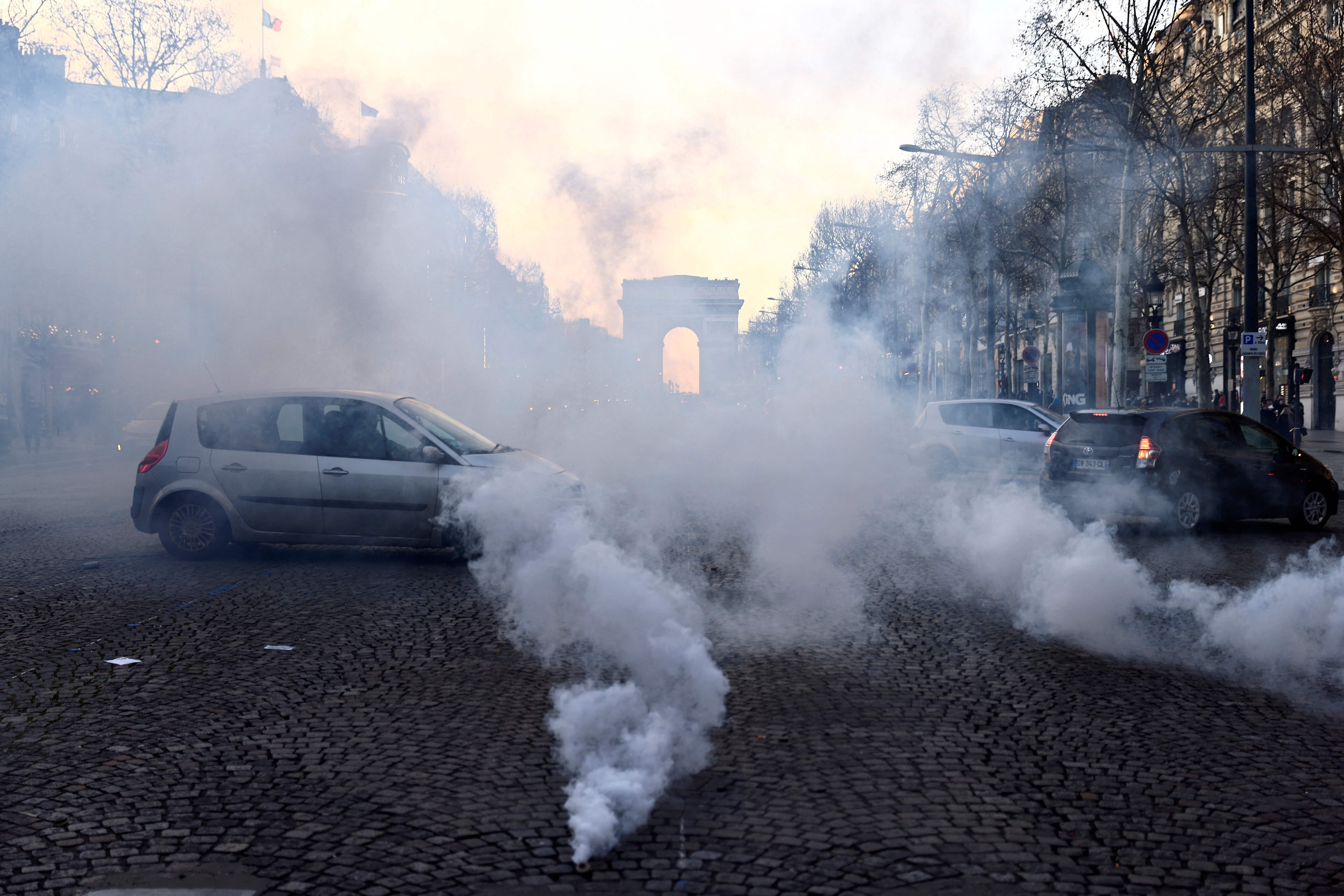 Motorists steer their cars on the Champs-Élysées in Paris on February 12, 2022 as convoys of protesters arrived in the French capital.