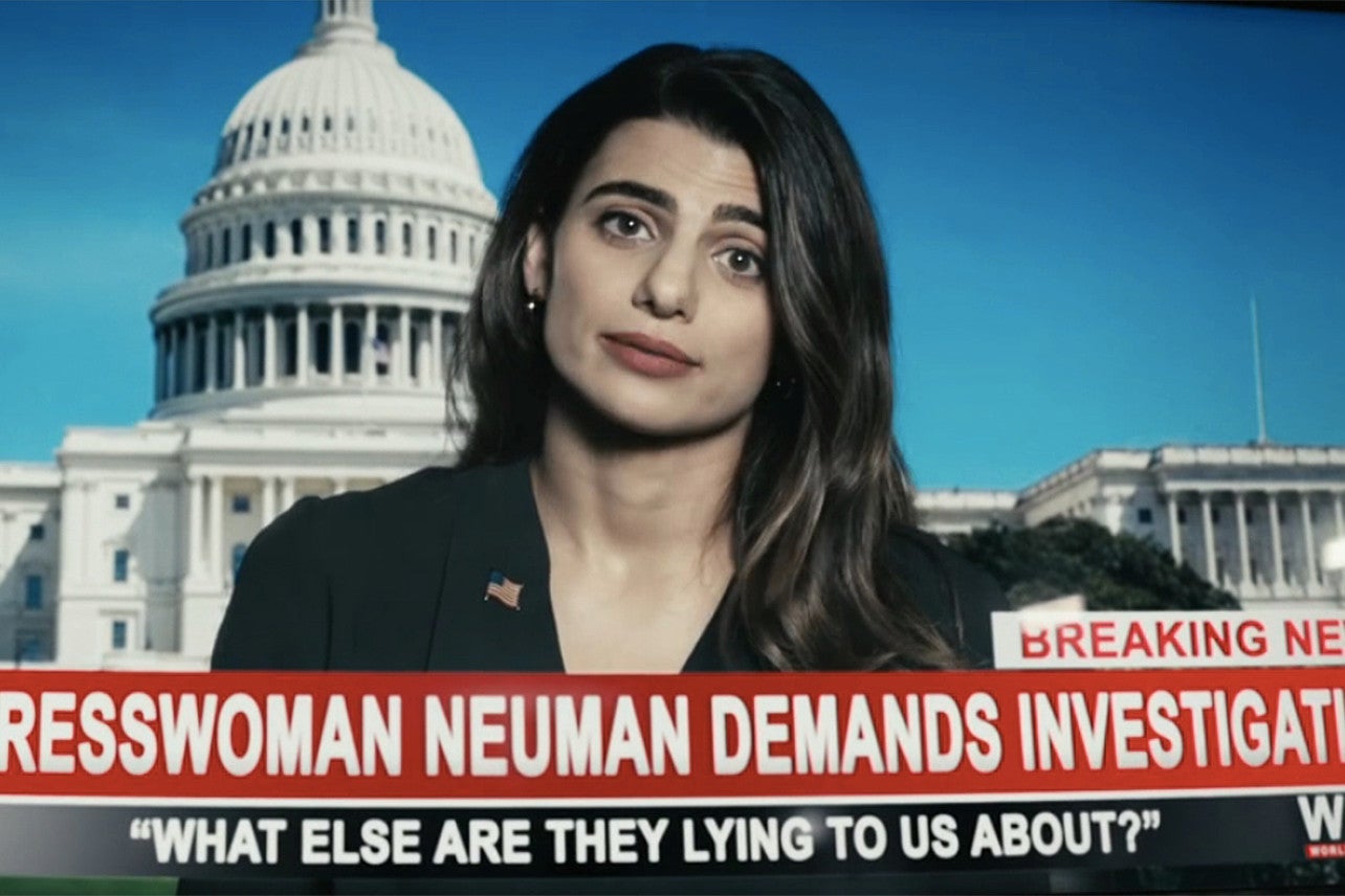 A Congresswoman on cable news with the US Capitol in the background, and a banner reading "What else are they lying to us about?"