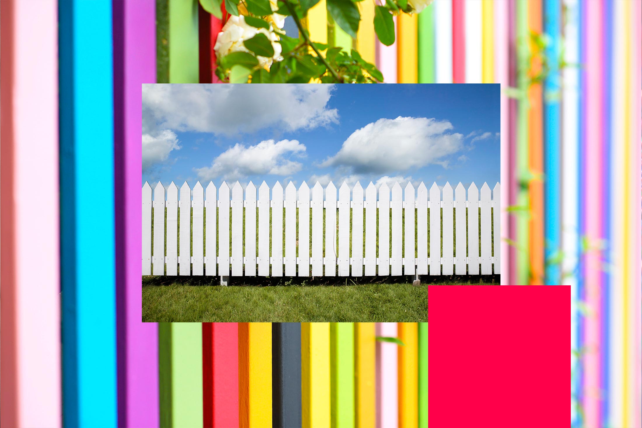Rainbow picket fence surrounding a white picket fence.