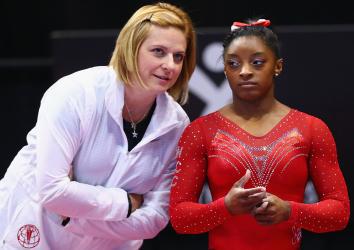 Simone Biles talks with her coach Aimee Boorman during warm ups before the Sr. Women's 2016 Secret U.S. Classic at the XL Center on June 4, 2016 in Hartford, Connecticut.  