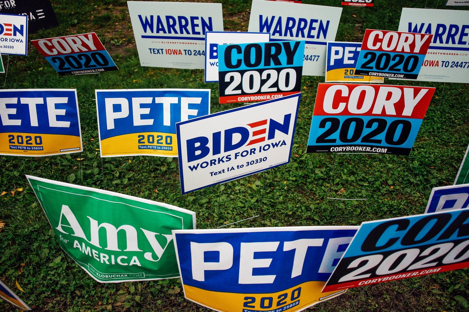 A mass of presidential campaign signs for Amy Klobuchar, Pete Buttigieg, Cory Booker, Joe Biden, and Elizabeth Warren are seen on a field