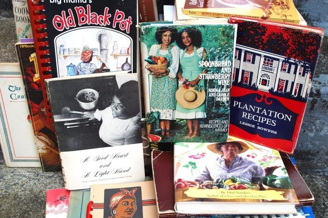 Lokelani's vast cookbook collection. Some titles include Old black pot, Spoonbread and strawberry wine, and plantation recipes.