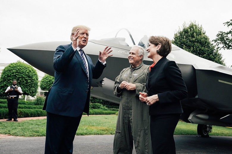U.S. President Donald Trump talks to Lockheed chief test pilot Alan Norman and CEO Martin Marillyn Hewson in front of an F-35 fighter jet during the 2018 Made in America Product Showcase on July 23.