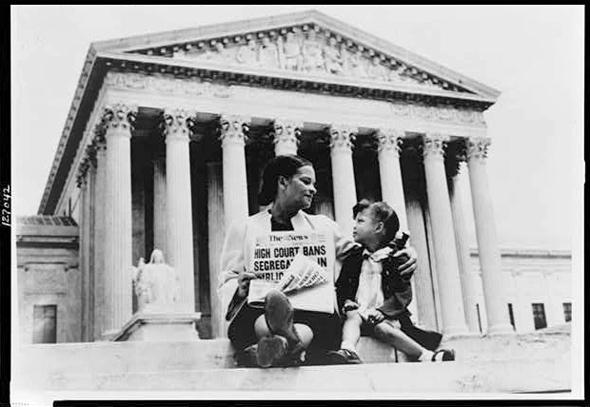 Nettie Hunt, sitting on the steps of the U.S. Supreme Court in Washington, D.C., explains the significance of the Court's May 17th, 1954 desegregation ruling to her daughter Nikie, 3, in Nov. 1954.