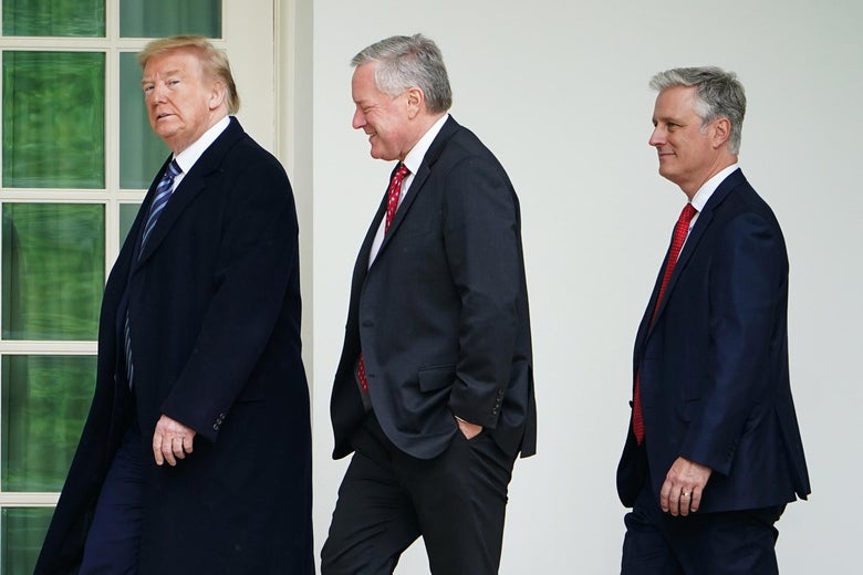 Trump walking outside the White House with Meadows, then O'Brien following close behind him.