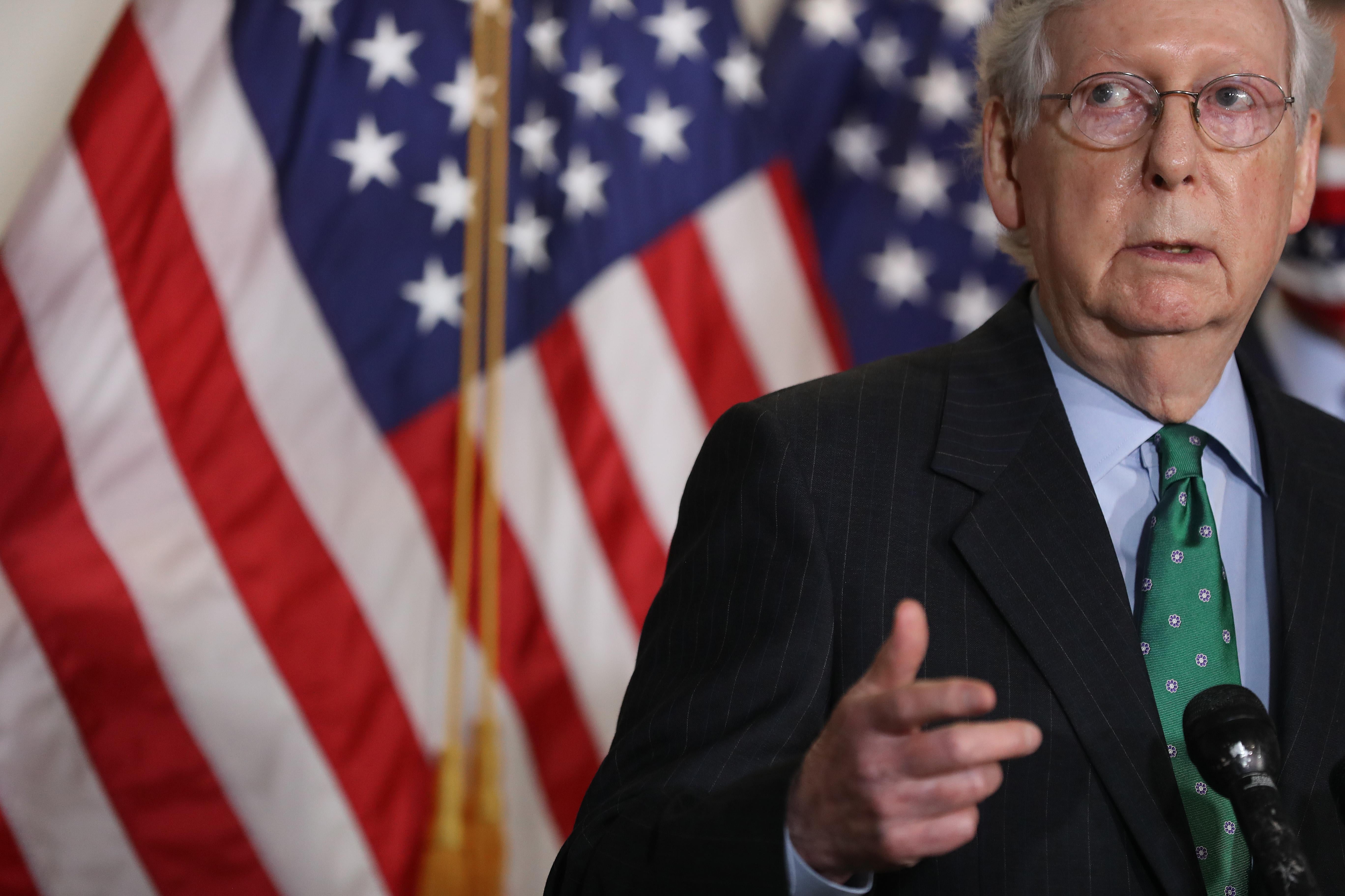 McConnell, standing at a podium, speaks to reporters on Capitol Hill on Sept. 30